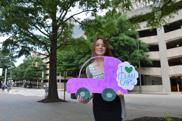 Person holding I Love Clean Cars photo petition