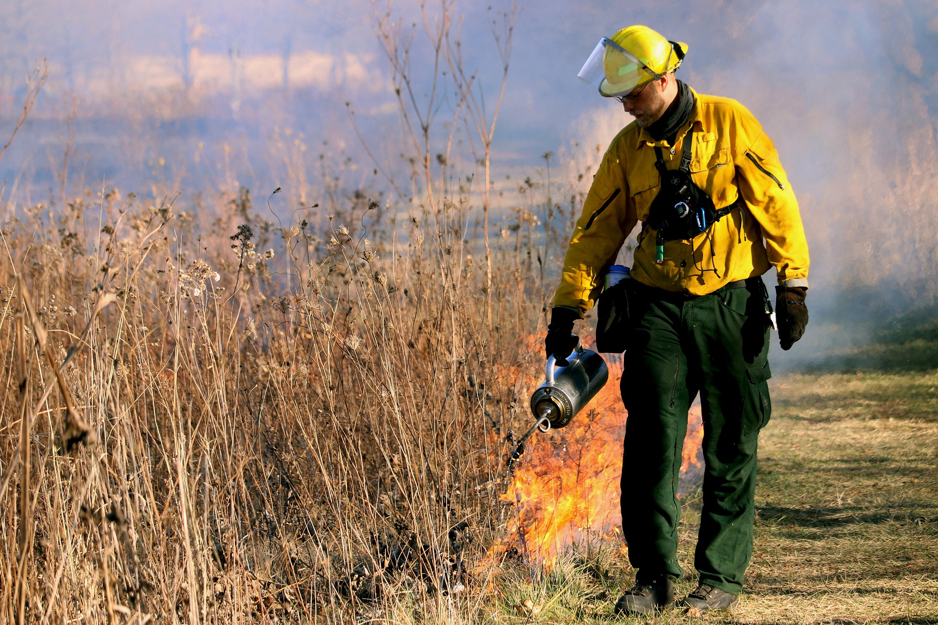 Firefighter safely performing a prescribed prairie fire