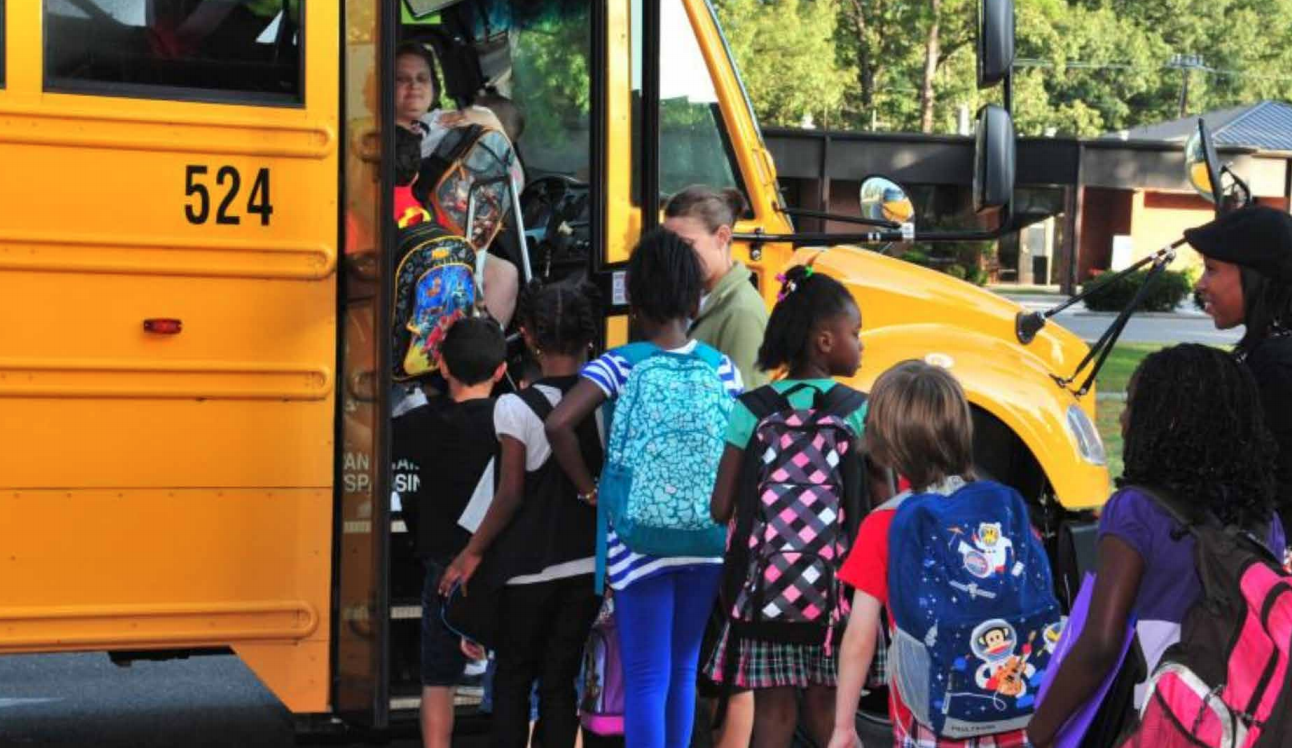 Kids boarding electric school bus