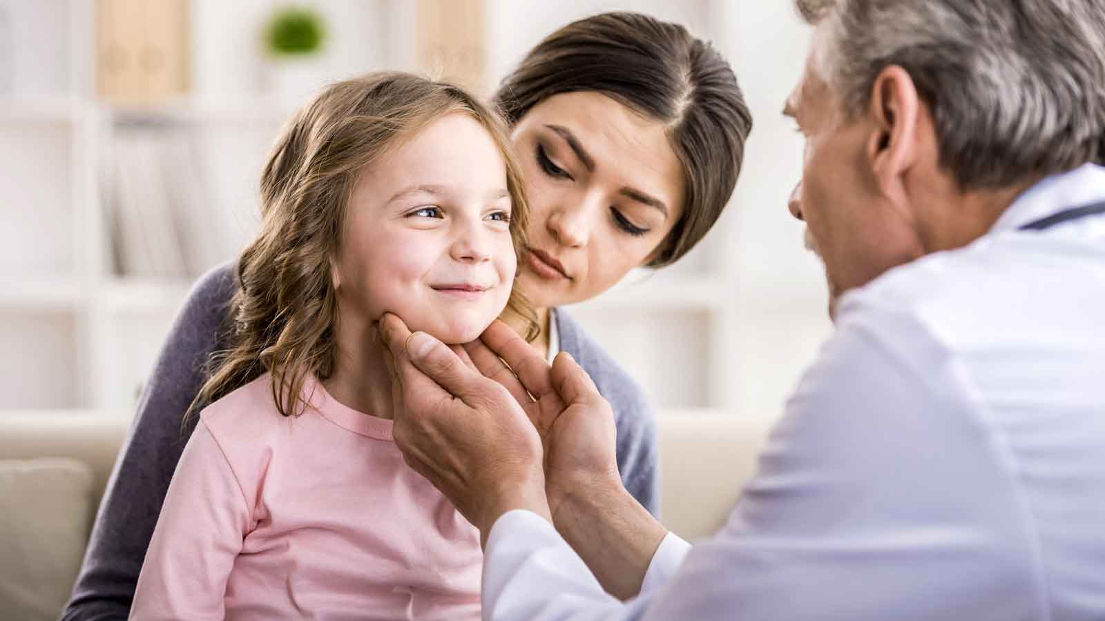 Doctor seeing child patient with parent