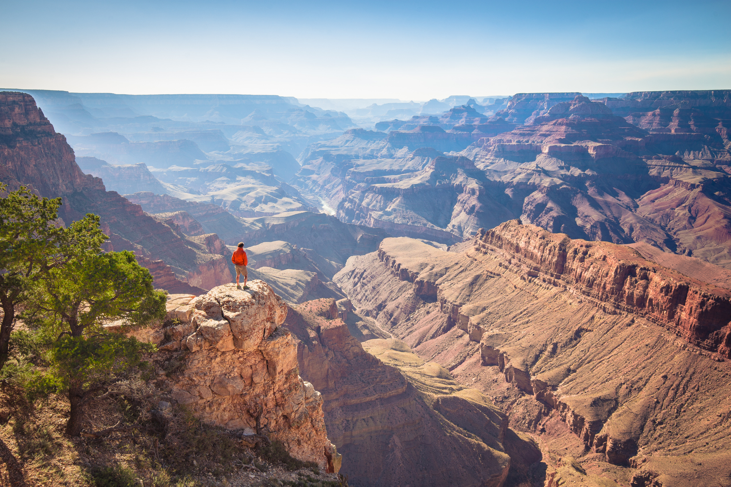 Hiker standing on vista overlooking Grand Canyon