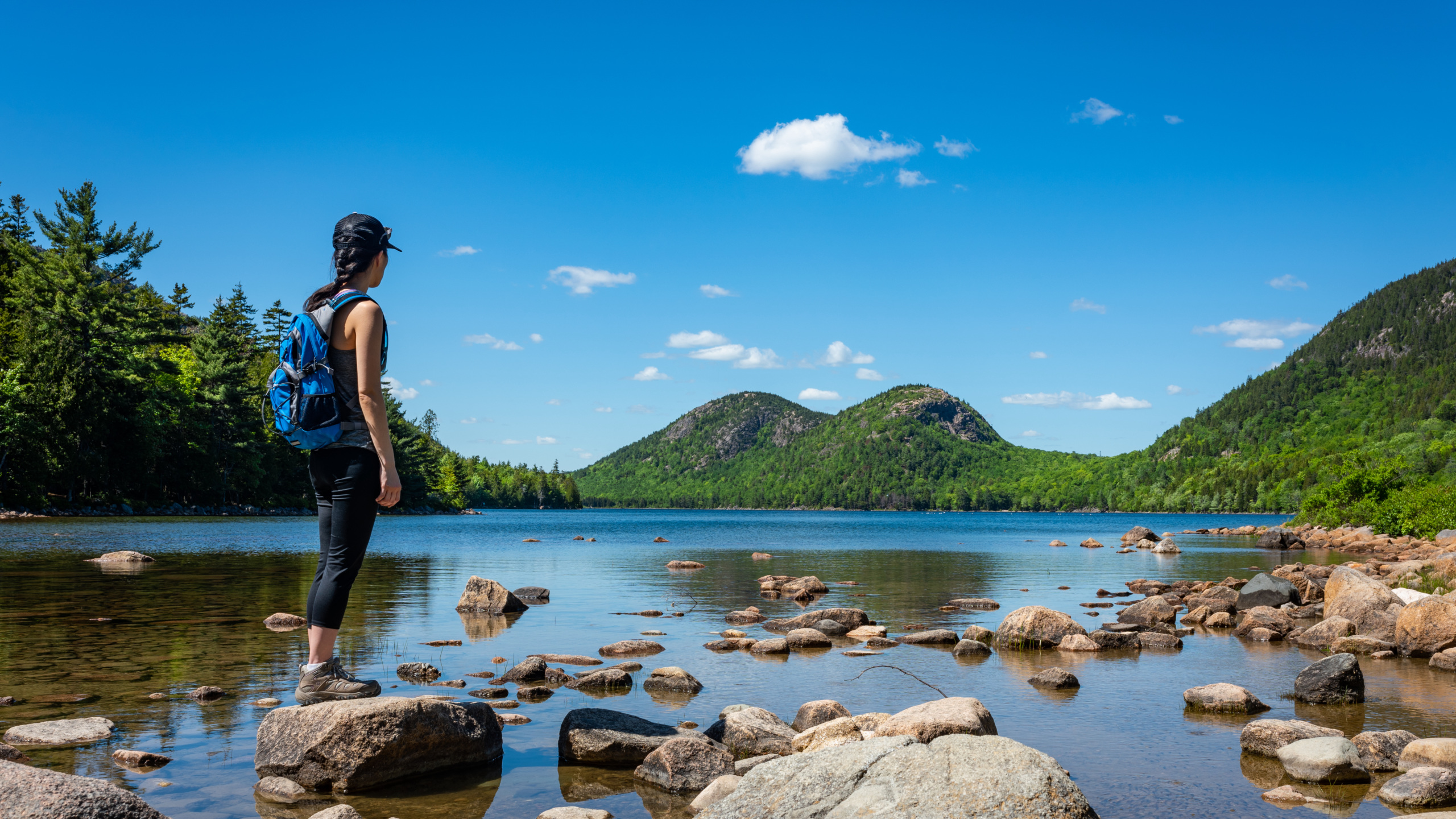 Woman hiking at Jordan Pond in Acadia National Park Maine