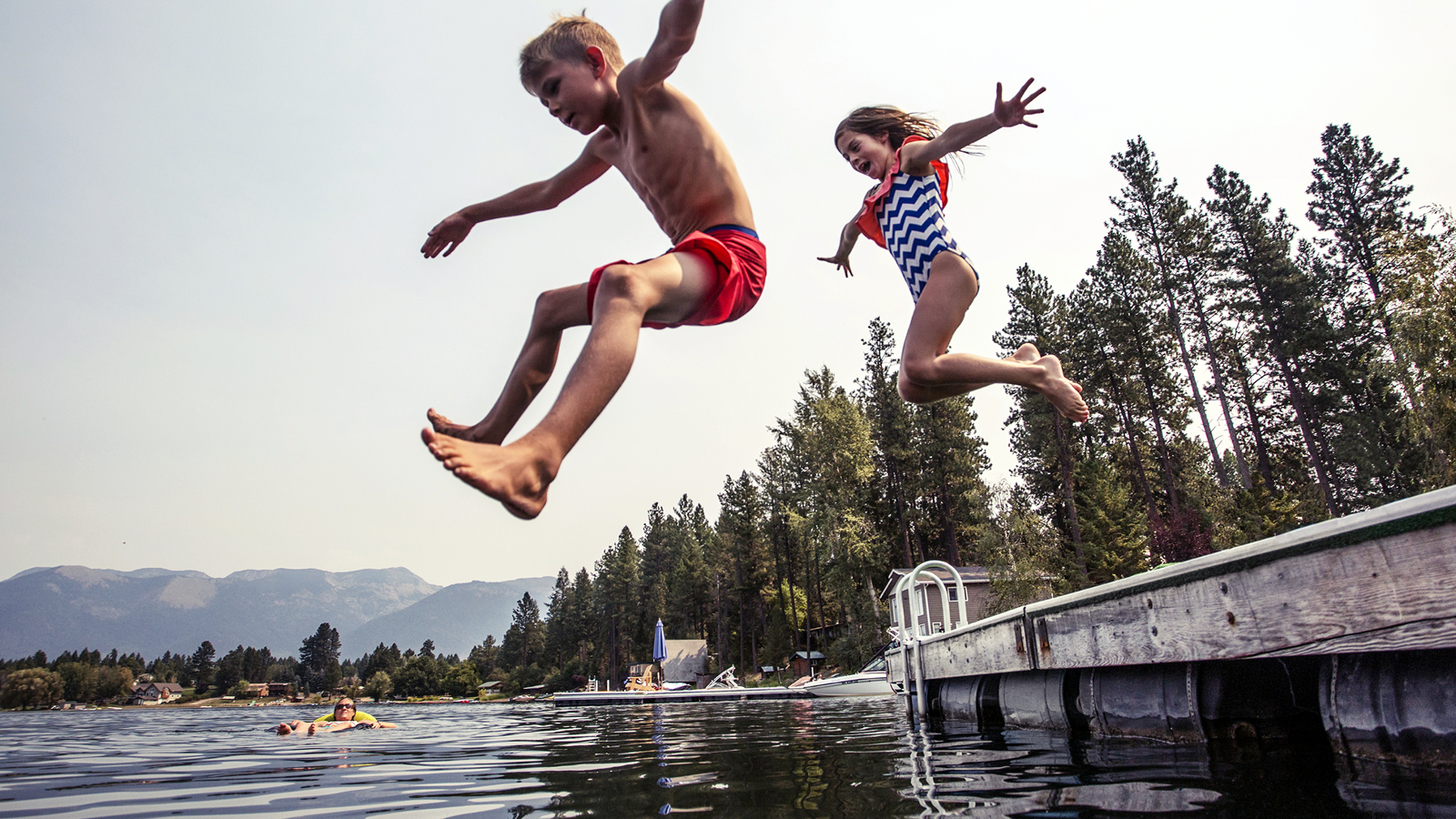 Kids jumping into lake