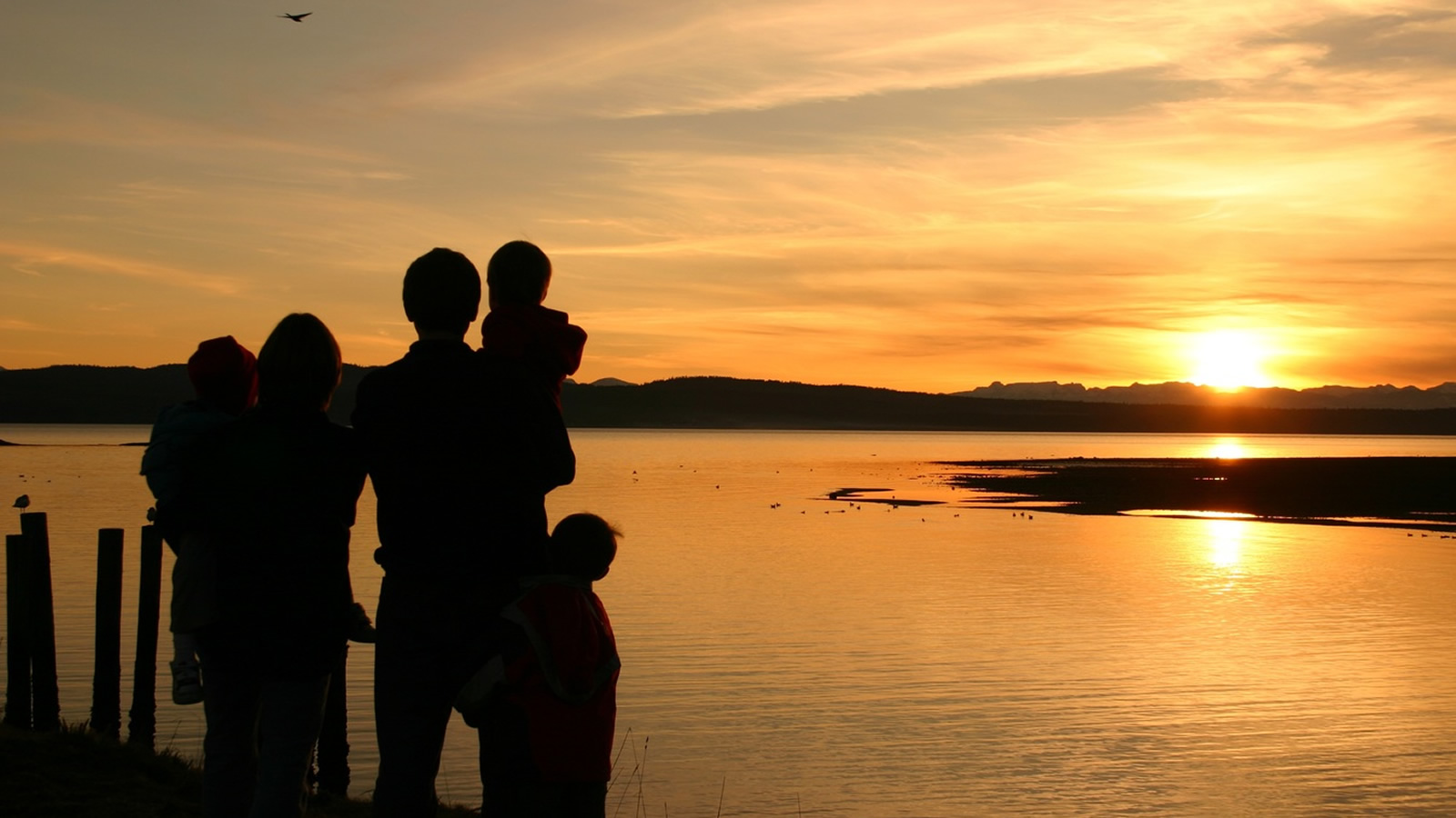 family with sunset in the background