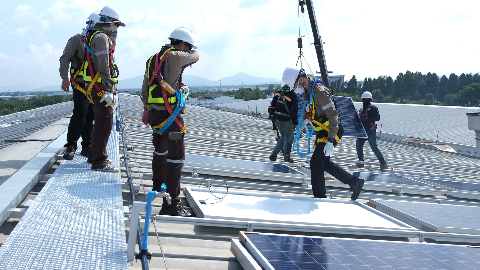 Workers doing rooftop solar installation