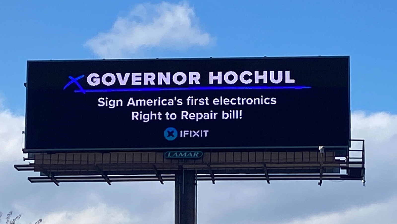 Billboard which reads Governor Hochul sign america's first electronics Right to Repair bill