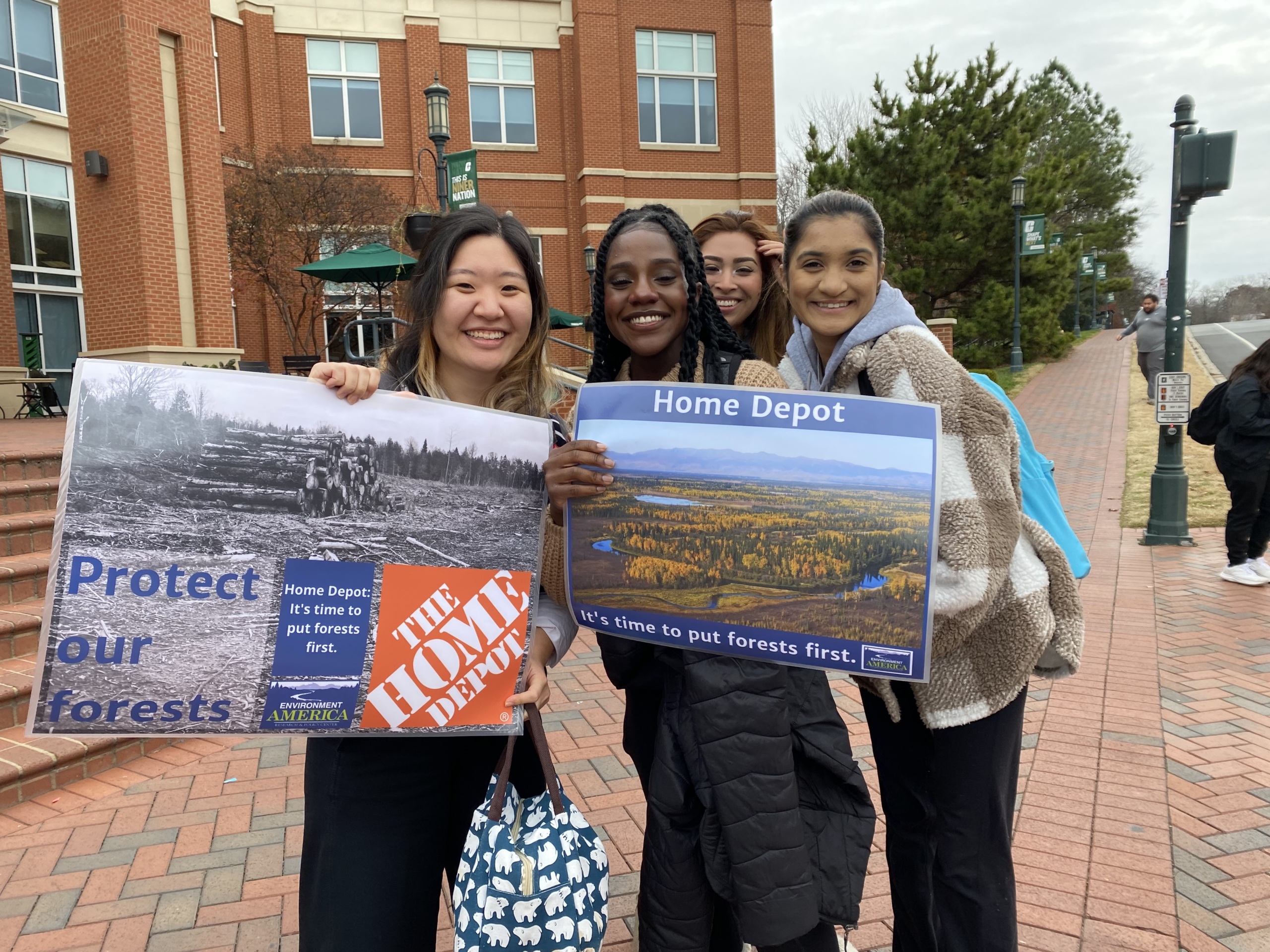 Group of students holding photo petition asking home depot to put forests first