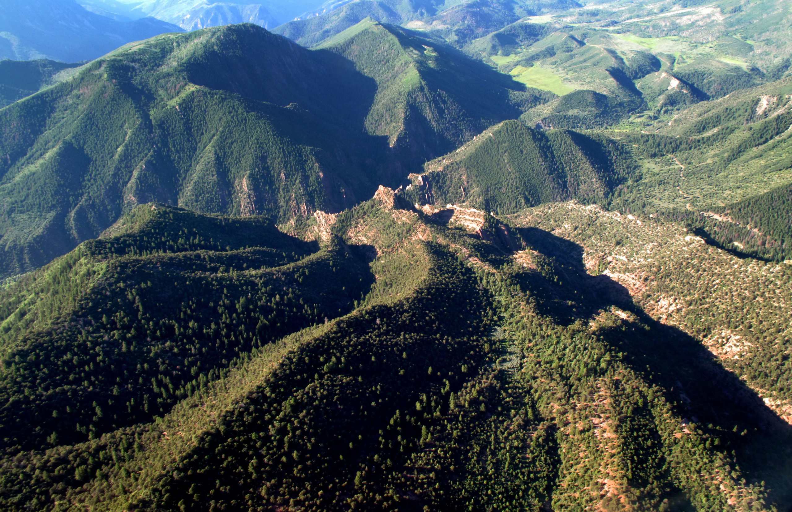 Thompson divide aerial shot -shows green mountains with dramatic shadows