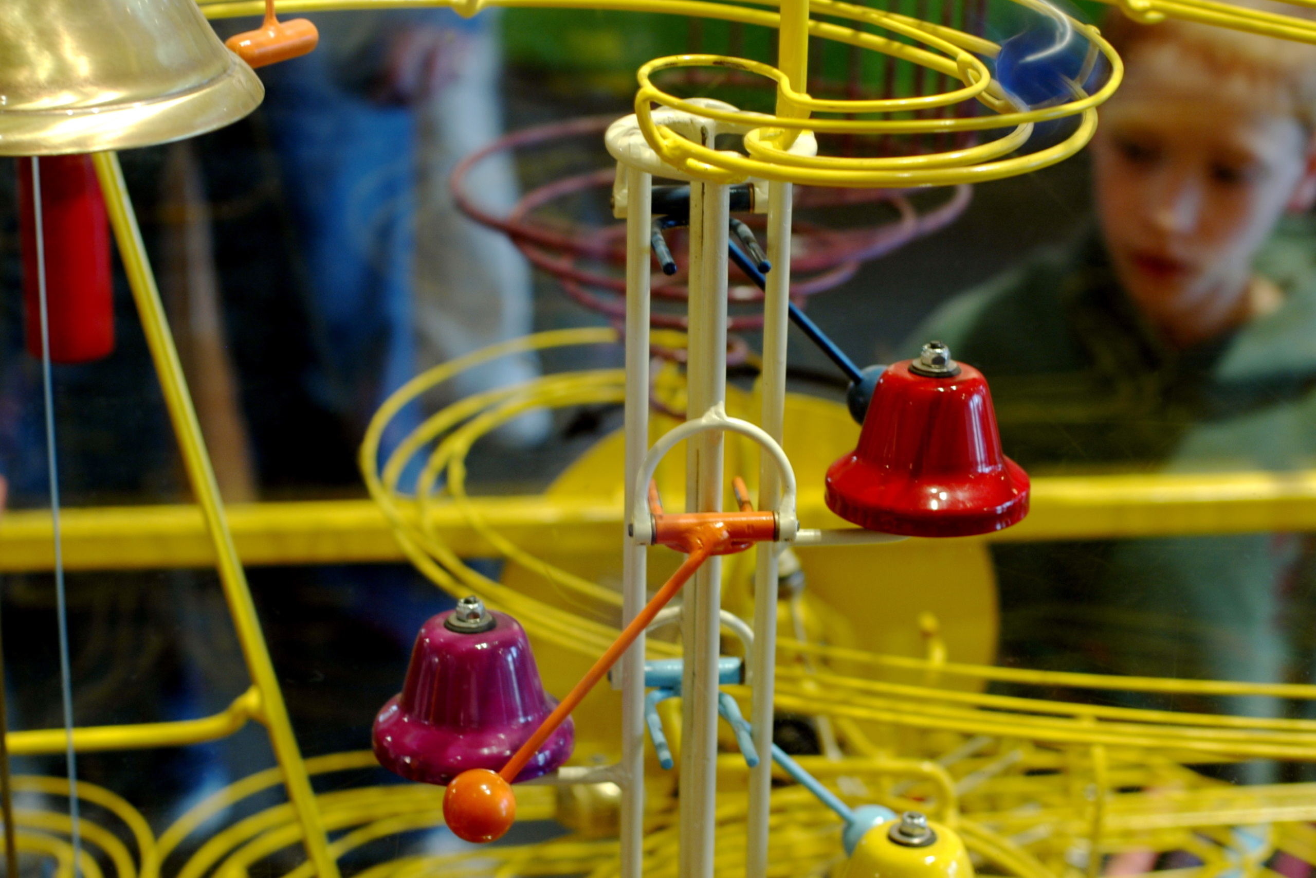 A child stands behind a Rube Goldberg Machine