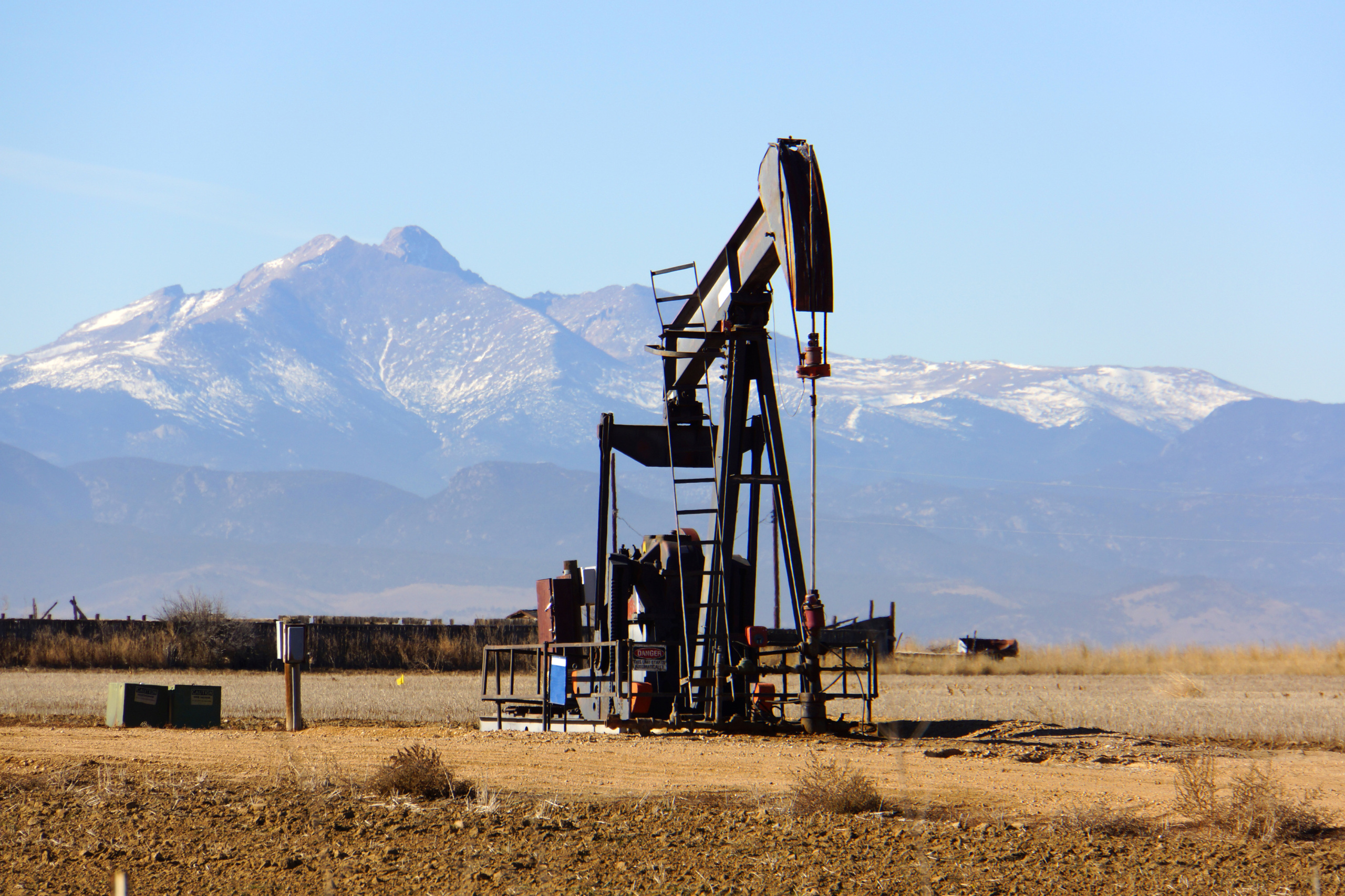 An oil pump in Colorado with Rocky Mountains in the background