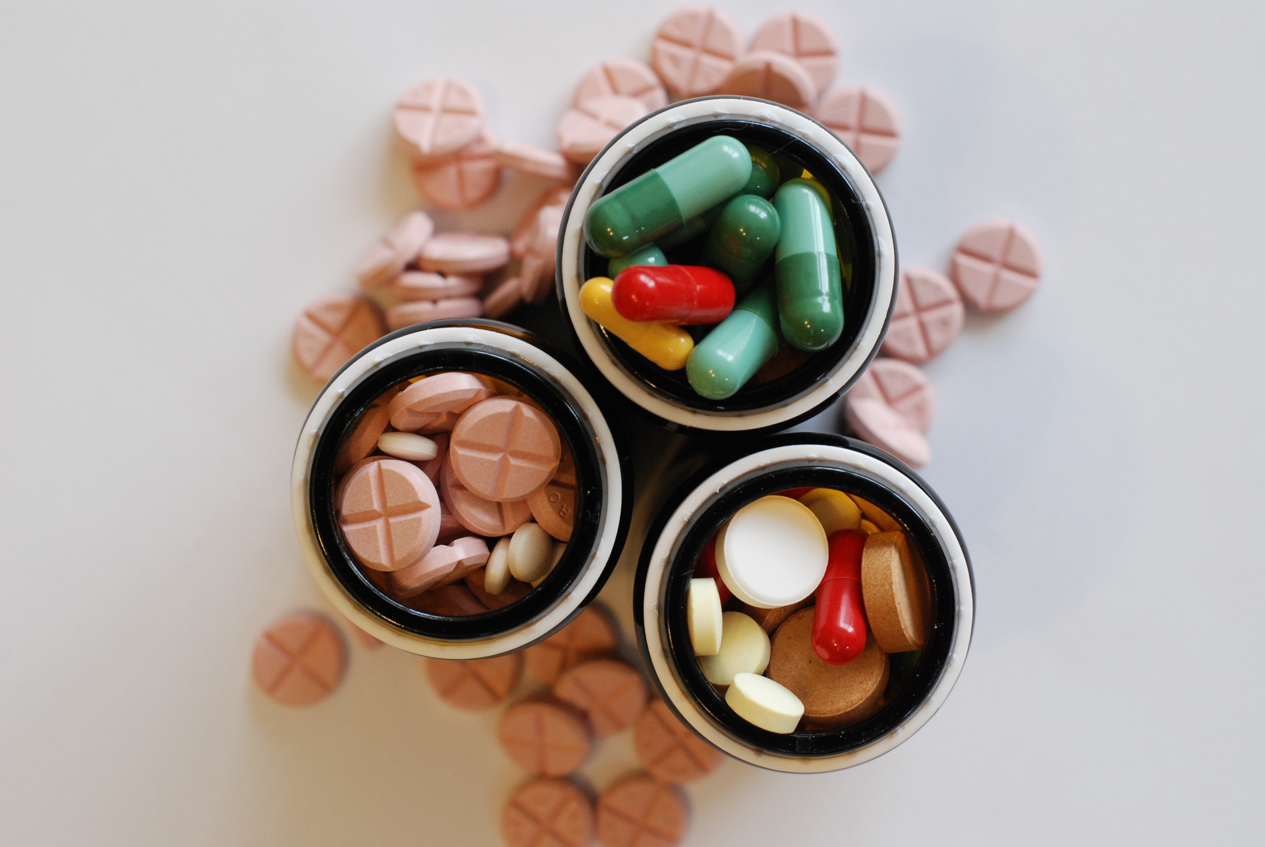 different colors and shapes of tablets and pills