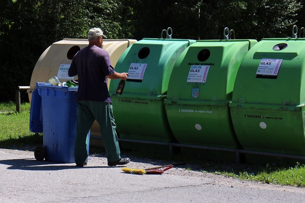 Man at recycling bins