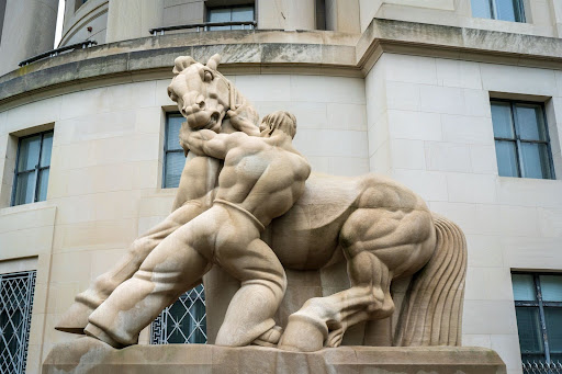 statue of man wrestling horse outside the Federal Trade Commission Office