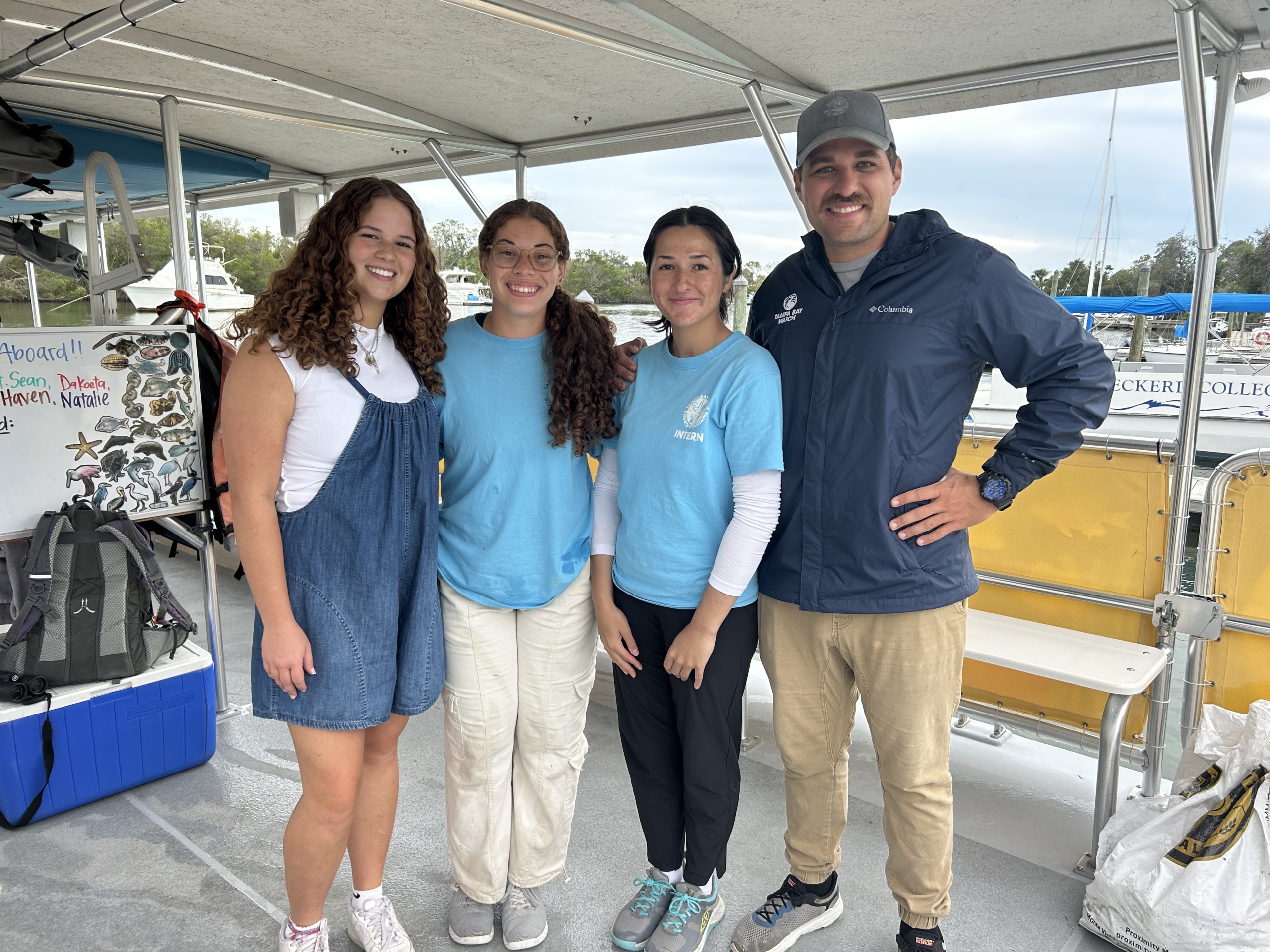 Students and educator onboard a pontoon boat