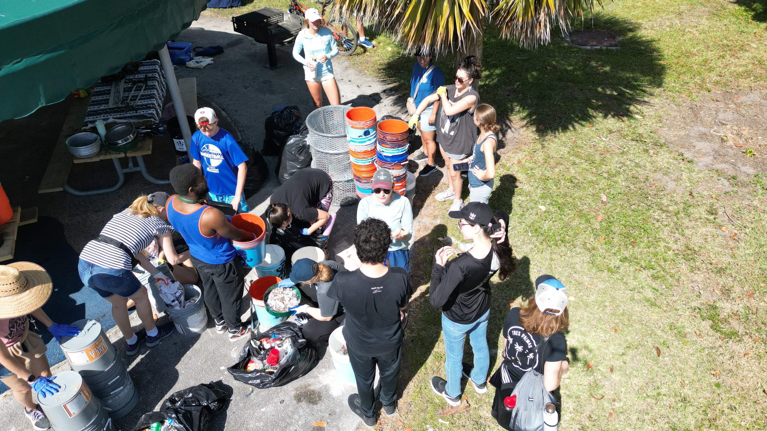 Overhead shot of people sorting trash in buckets