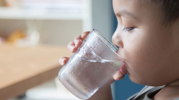 A child drinking tap water
